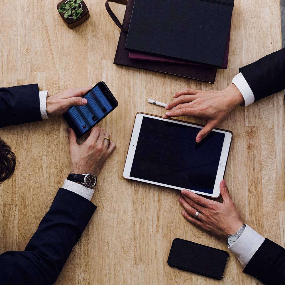 Hands and phones of business people meeting